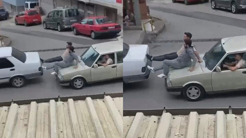 Otomobilin kaputuna oturup arabayı itti!